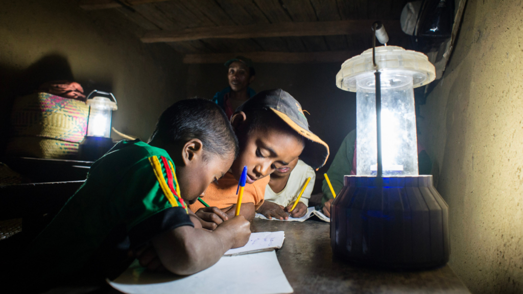 Children learning by the light of solar lanterns in Madagascar. Solar light was installed by a Barefoot College International solar engineer.
