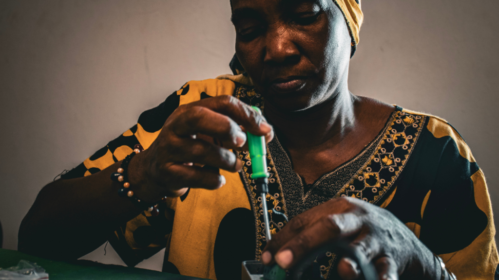 Mariatou, a solar engineer training with Barefoot College International uses a screwdriver to build solar equipment as she trains with Barefoot College International as a rural woman solar engineer