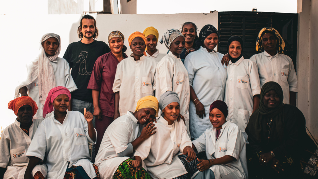 A group of solar trainees with Barefoot College International gather for a photo in Senegal with their trainer